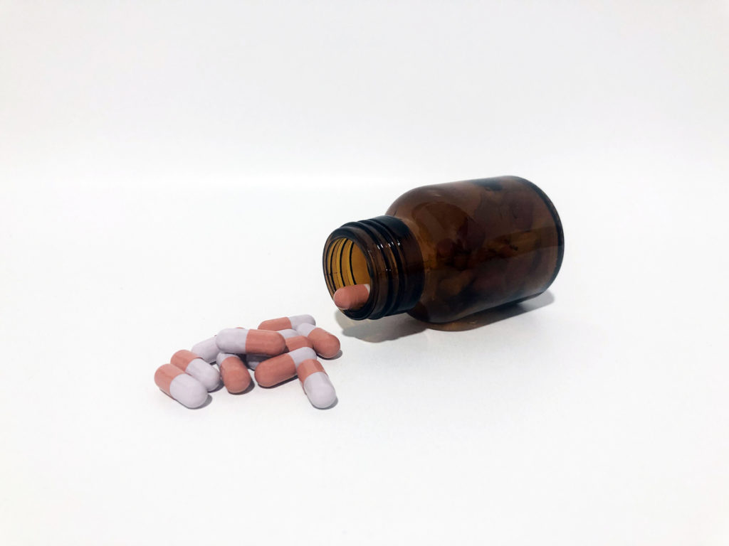 Medicine Pills or Tablets Drop and Out of the Brown Glass Bottle.