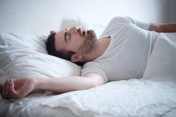 Man with sleep apnea snoring