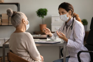 Physician and elderly patient discussing social security disability