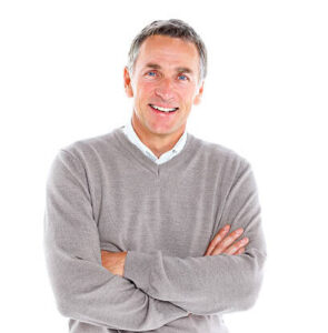 Portrait of cheerful mature man standing with his arms crossed on white background