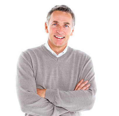Portrait of cheerful mature man standing with his arms crossed on white background